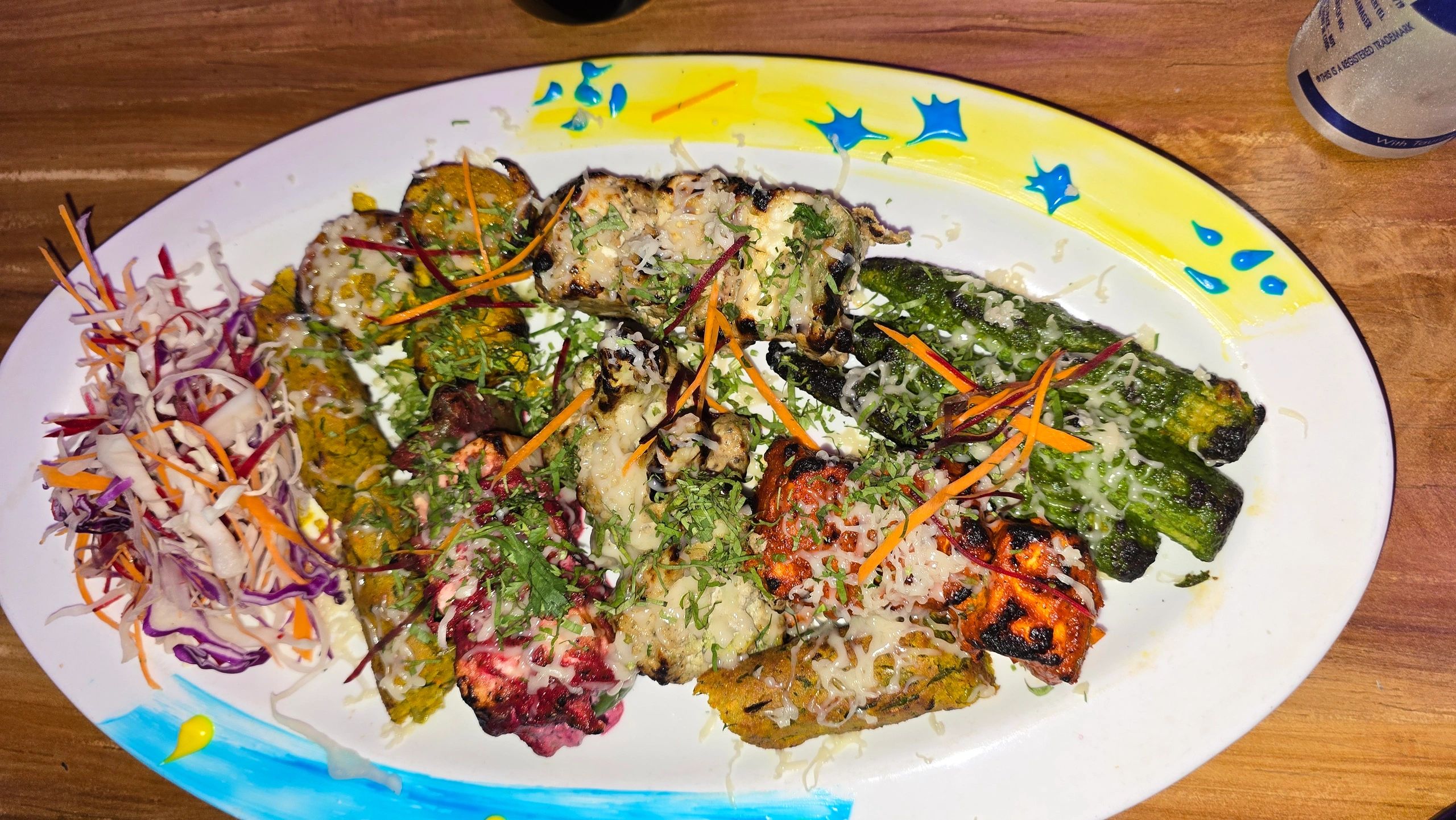Assorted Indian tandoori platter with paneer, grilled vegetables, and salad